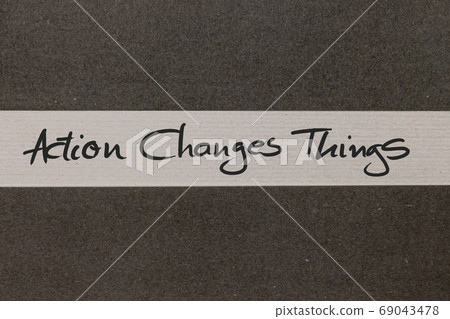 White and Grey coloured paper background with Action Changes Things motivational handwritten message White and Grey coloured paper background with Action Changes Things motivational handwritten message 69043478