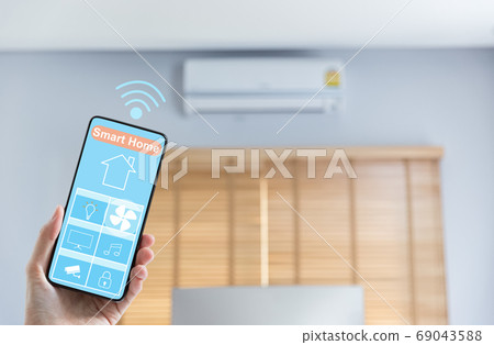 hand holding mobile phone with smart home screen hand holding mobile phone with smart home screen 69043588