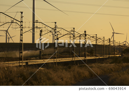 Train tracks landscape and wind turbines in Spain Train tracks landscape and wind turbines in Spain 69043914