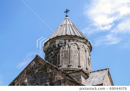Stone umbrella dome with iron cross at the Church of Blessed Holy Mother,in the monastery of Haghartsin near Dilijan Stone umbrella dome with iron cross at the Church of Blessed Holy Mother,in the monastery of Haghartsin near Dilijan 69044076