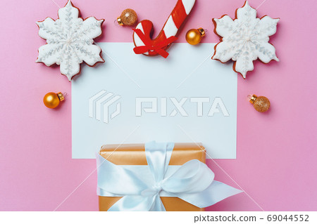Mock up of holiday greeting card with gingerbread cookies on pink background 69044552