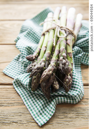 Asparagus on old wooden background. Asparagus on old wooden background. 69044984