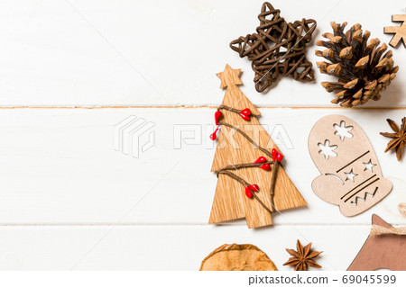 Top view of Christmas decorations and toys on wooden background. Top view of Christmas decorations and toys on wooden background. 69045599