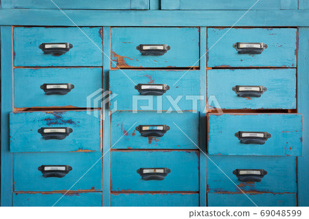 Old turquoise and brown colored wooden cabinet with drawers background Old turquoise and brown colored wooden cabinet with drawers background 69048599