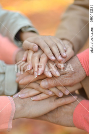 Cropped image, family putting hands together close up  69048885