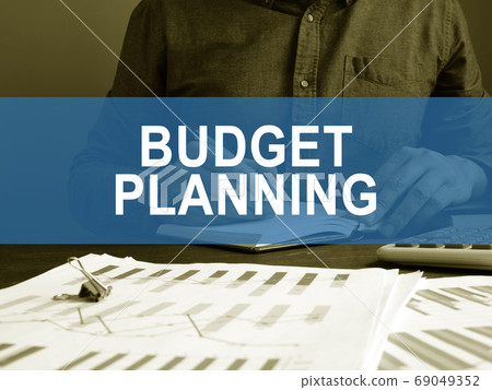 Budget planning concept. A man works with business papers. Budget planning concept. A man works with business papers. 69049352