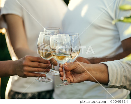 Wine glasses in hands Wine glasses in hands 69049514