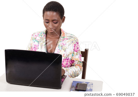 Young woman working on a laptop at the office. 69049837