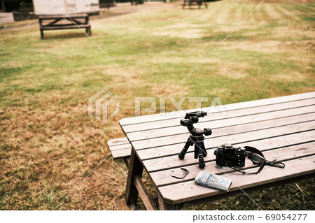 Photography equipment on the table in the park at dusk around 6pm in the evening in August 69054277