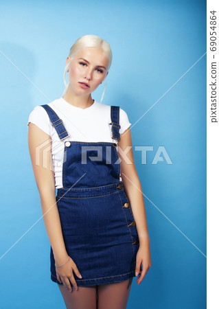 young pretty teenage modern hipster girl posing emotional happy on blue background, lifestyle people concept young pretty teenage modern hipster girl posing emotional happy on blue background, lifestyle people concept 69054864