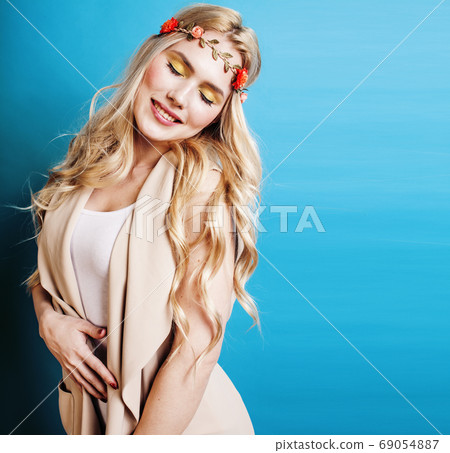 young blond woman dressed like ancient greek godess, jewelry close up isolated, beautiful girl hands manicured red nails on blue background copyspace young blond woman dressed like ancient greek godess, jewelry close up isolated, beautiful girl hands manicured red nails on blue background copyspace 69054887