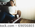 A women looking at notebook at home. working concept. 69056803