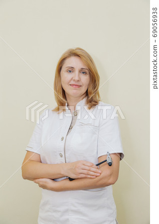 Woman neurologist at the yellow wall in a private 69056938