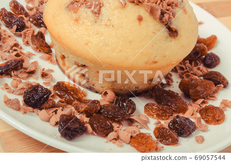 Fresh baked muffins with raisins. Delicious dessert Fresh baked muffins with raisins. Delicious dessert 69057544