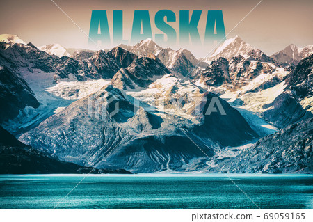 Alaska Glacier Bay landscape National Park, USA. Alaska text written as title above mountain top for cruise destination. Background of snow capped mountains peaks at sunset winter vacation 69059165