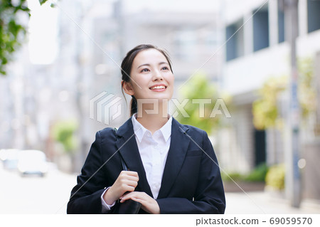 Young business woman standing in office district 69059570