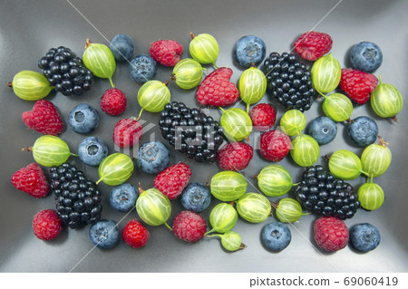 lots of fresh different berries. useful vitamin healthy food fru 69060419
