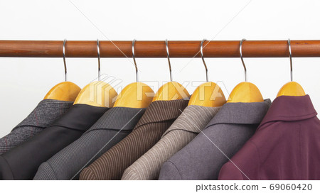 Different women's office classic jackets hang on a hanger for st 69060420