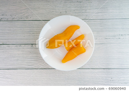 Ubi rebus or steam cassava is traditional malay dish on wooden background Ubi rebus or steam cassava is traditional malay dish on wooden background 69060940