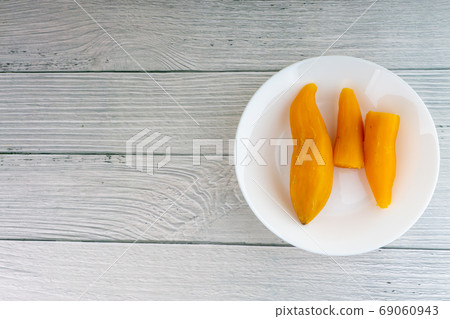 Ubi rebus or steam cassava is traditional malay dish on wooden background 69060943