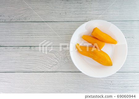 Ubi rebus or steam cassava is traditional malay dish on wooden background 69060944