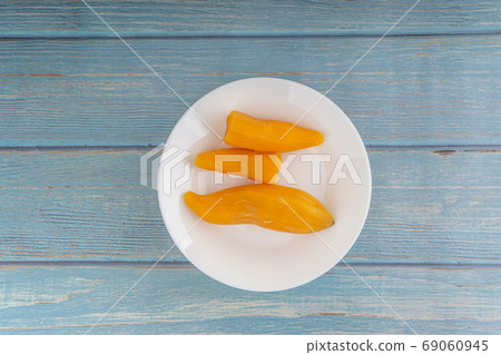 Ubi rebus or steam cassava is traditional malay dish on wooden background Ubi rebus or steam cassava is traditional malay dish on wooden background 69060945