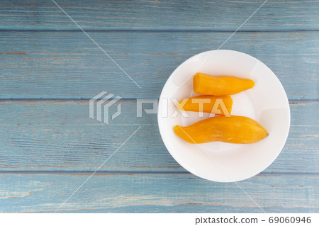Ubi rebus or steam cassava is traditional malay dish on wooden background 69060946