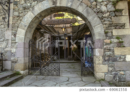 Beautiful wrought iron gate with stone arch at the entrance to the bakery on Sharambeyan street in  old Dilijan 69061558
