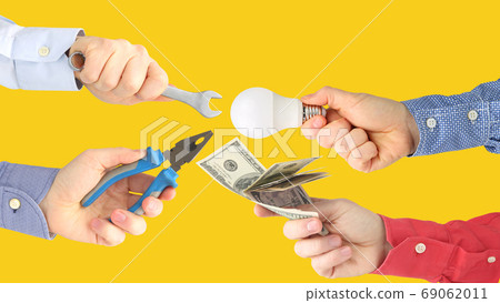 male hands with work tools and money. business relationship. pay male hands with work tools and money. business relationship. pay 69062011