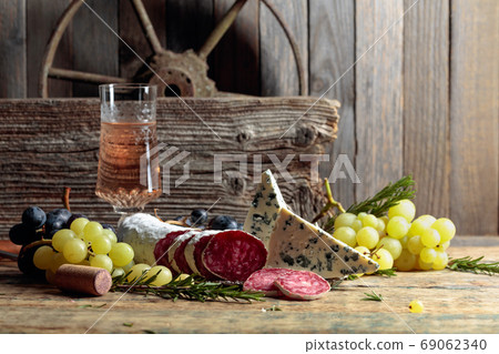 Rustic still life with wine and snacks. Rustic still life with wine and snacks. 69062340