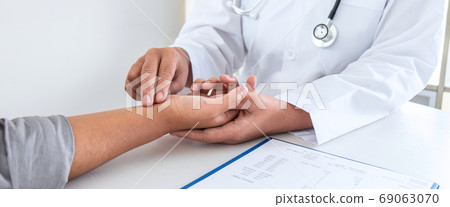 Doctor checking measuring pressure on patient's Doctor checking measuring pressure on patient's 69063070