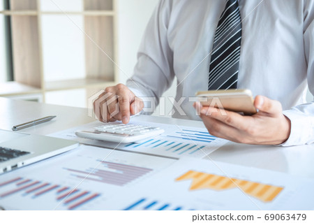 Young business man or accountant working on laptop 69063479