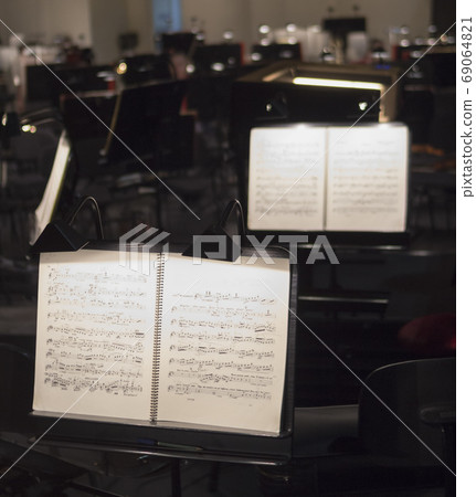 Orchestra music stands . Musical notes on wooden table. Orchestra music stands . Musical notes on wooden table. 69064821