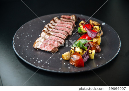 Beef tagliata meat with grilled vegetables 69064907