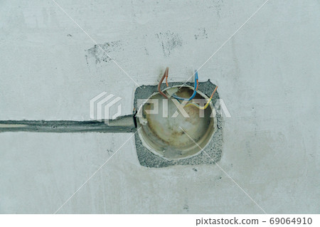 Holes in the concrete wall in the room for sockets 69064910