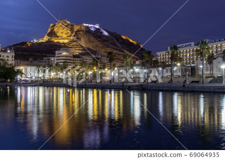 Night view of View of Alicante port Castle Santa Barbara on Mongo mount in background. Javea Xabia village. Night view of View of Alicante port Castle Santa Barbara on Mongo mount in background. Javea Xabia village. 69064935