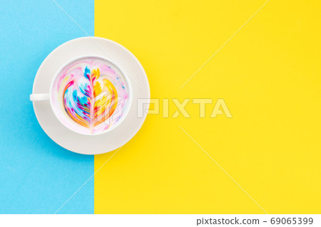 Top view white cup of hot Latte art coffee on yellow 69065399