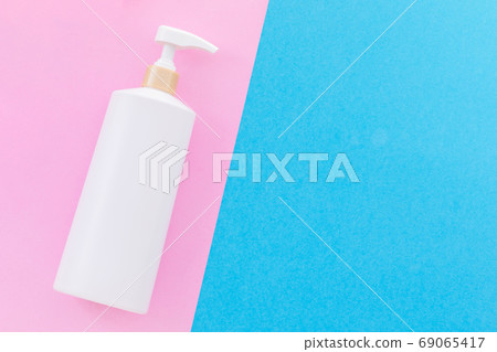 Blank white plastic pump bottle used for shampoo or soap on blue 69065417