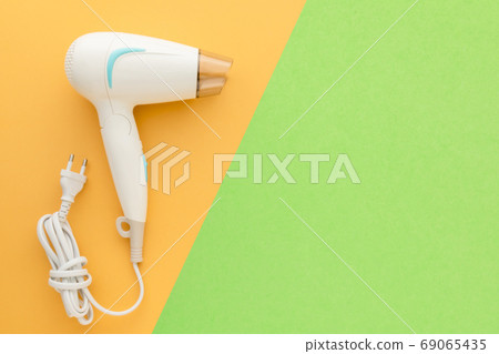 New white hair dryer with cable on pink background with copy spa New white hair dryer with cable on pink background with copy spa 69065435