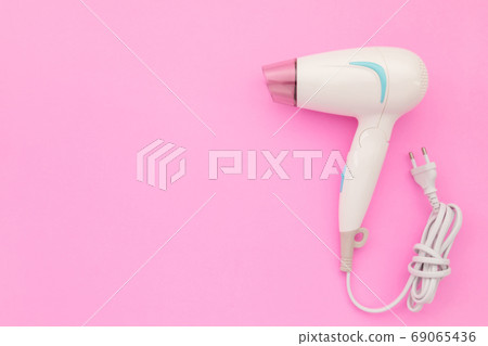 New white hair dryer with cable on pink background with copy spa New white hair dryer with cable on pink background with copy spa 69065436