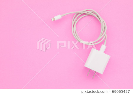 New white smartphone charger on pink background with copy space New white smartphone charger on pink background with copy space 69065437
