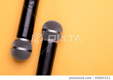 Black wireless microphone on color background. Copy space for te 69065521