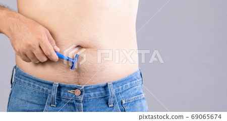 Portrait man using razor blade to cutting belly and body hair. S Portrait man using razor blade to cutting belly and body hair. S 69065674
