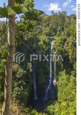 Sekumpul Waterfalls surrounded by tropical forest in Bali, Indonesia. Sekumpul Waterfalls surrounded by tropical forest in Bali, Indonesia. 69065834