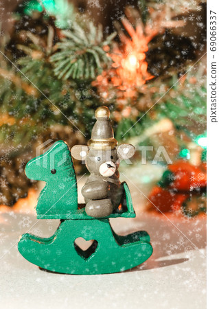 wooden Christmas tree toy on the background of festive illuminat 69066337