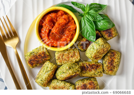 baked broccoli tots on a plate, top view baked broccoli tots on a plate, top view 69066688