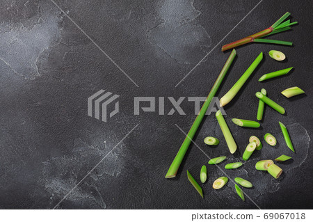 Lemongrass, cut stems atop dark textured backdrop w/ copy space, Lemongrass, cut stems atop dark textured backdrop w/ copy space, 69067018