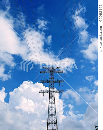 Steel tower standing against the blue sky and white clouds 69068161