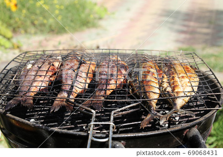 Fresh sea fishes on the grill outdoors. Fresh sea fishes on the grill outdoors. 69068431