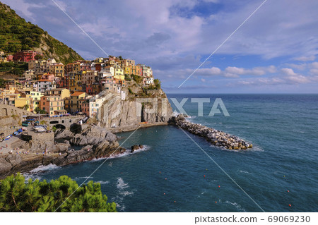 Colorful traditional houses on the rock over Mediterranean sea, Manarola, Cinque Terre, Italy Colorful traditional houses on the rock over Mediterranean sea, Manarola, Cinque Terre, Italy 69069230